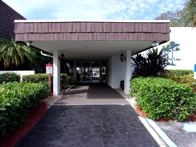 entrance to property featuring a carport