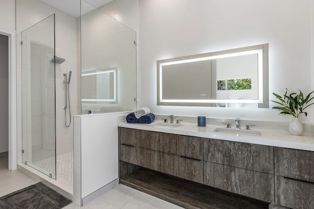 bathroom with tiled shower, vanity, and tile patterned flooring