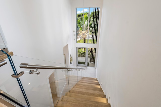 stairway with a towering ceiling and french doors