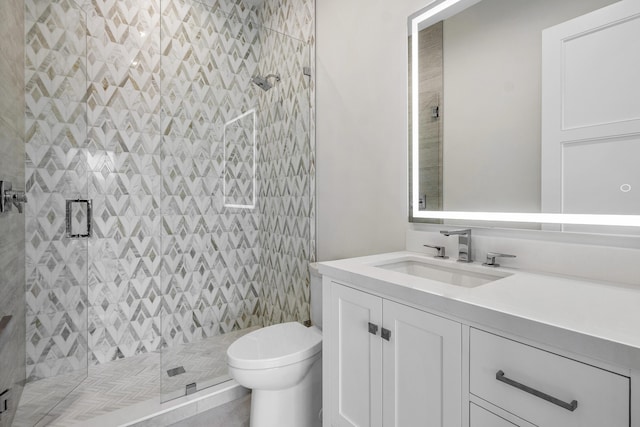 bathroom featuring tile patterned floors, vanity, toilet, and walk in shower