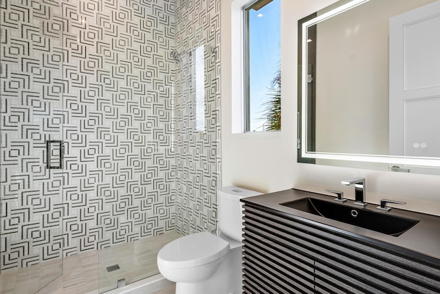 bathroom featuring an enclosed shower, vanity, and toilet