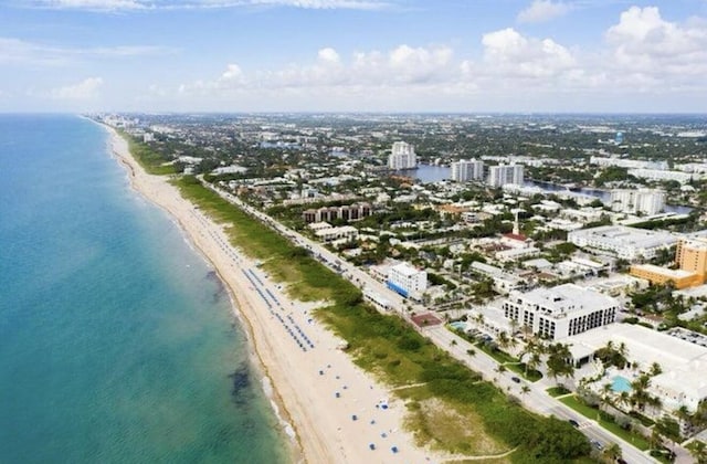 bird's eye view featuring a water view and a view of the beach