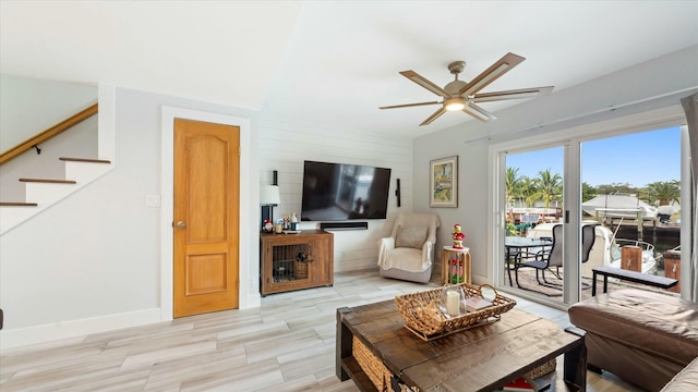 living room featuring ceiling fan and light hardwood / wood-style floors