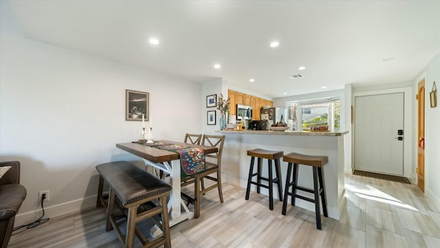 dining area featuring light wood-type flooring