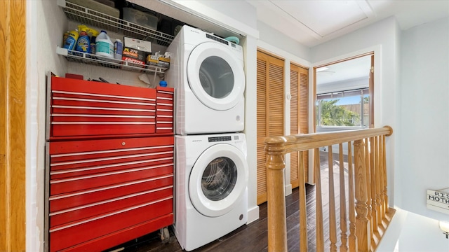 washroom with stacked washing maching and dryer and dark hardwood / wood-style floors