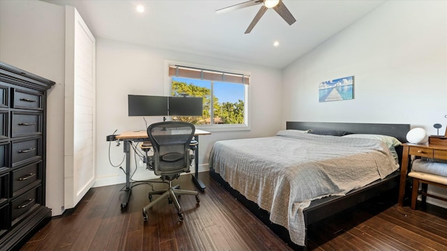 bedroom featuring dark hardwood / wood-style floors, ceiling fan, and vaulted ceiling