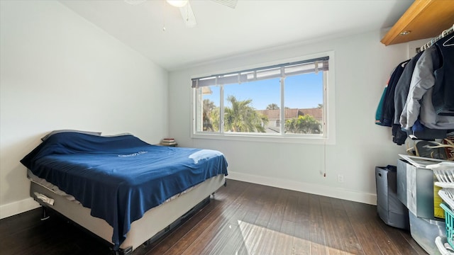 bedroom with dark hardwood / wood-style floors, ceiling fan, and lofted ceiling