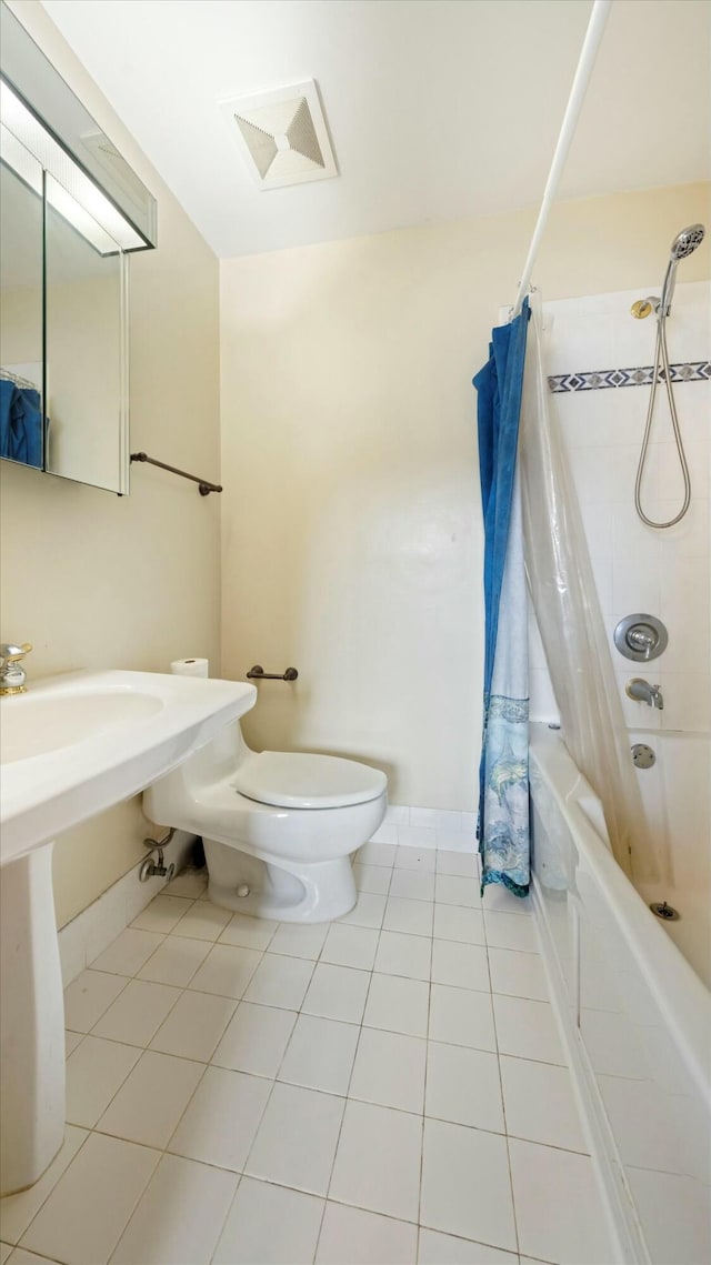 bathroom featuring tile patterned floors, toilet, and shower / bathtub combination with curtain