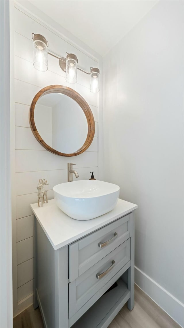 bathroom with hardwood / wood-style floors and vanity