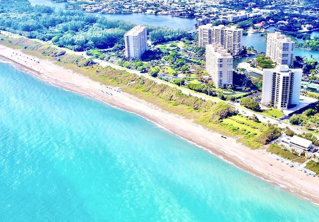 drone / aerial view featuring a water view and a view of the beach