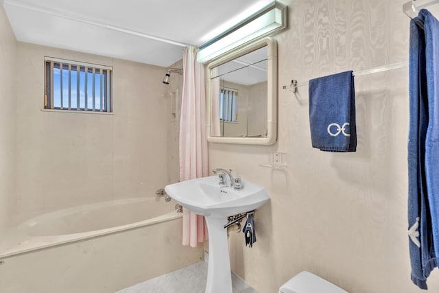 bathroom with shower / tub combo, toilet, and tile patterned floors