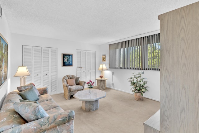 carpeted living room featuring a textured ceiling