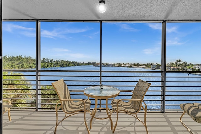 unfurnished sunroom with a water view