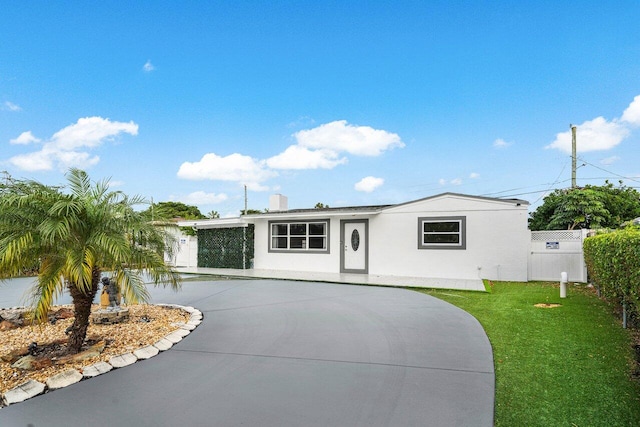 view of front of property featuring a garage and a front lawn