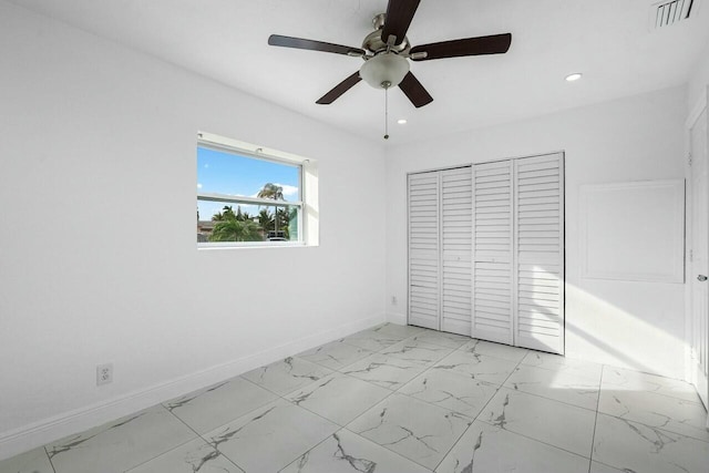 unfurnished bedroom featuring ceiling fan and a closet