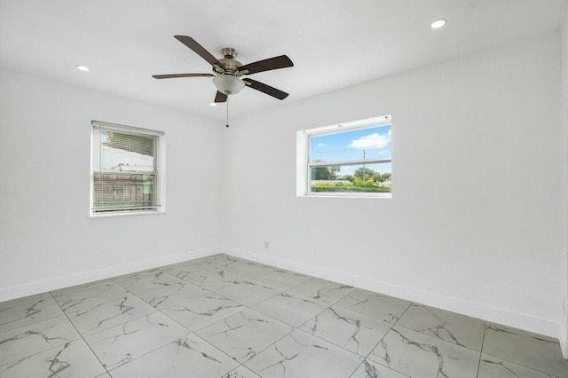 unfurnished room with ceiling fan and a healthy amount of sunlight