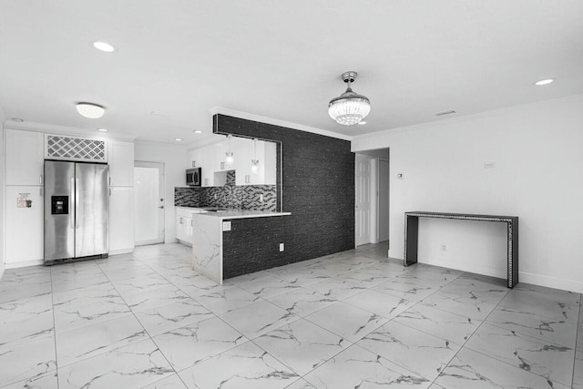 kitchen with backsplash, white cabinets, hanging light fixtures, ornamental molding, and stainless steel appliances