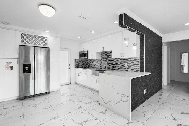 kitchen with white cabinets, stainless steel appliances, decorative light fixtures, and ornamental molding