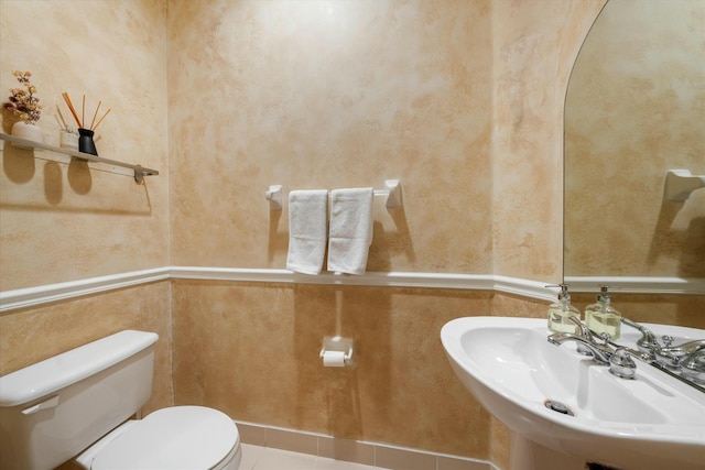 bathroom featuring tile patterned flooring, toilet, and sink