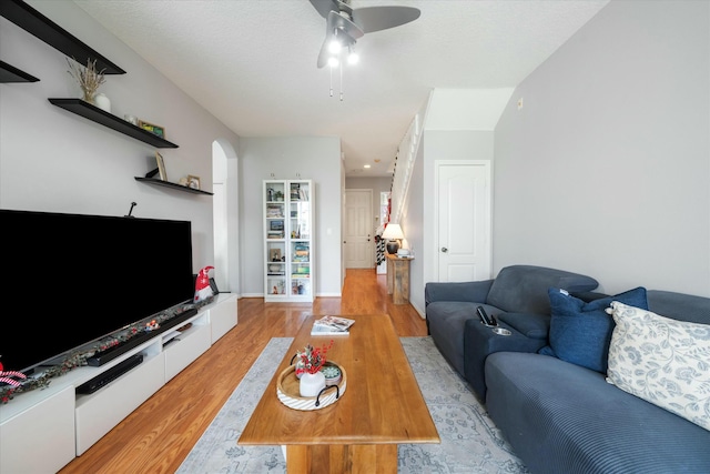 living room featuring ceiling fan and light hardwood / wood-style flooring