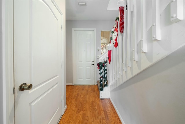 corridor with light hardwood / wood-style flooring