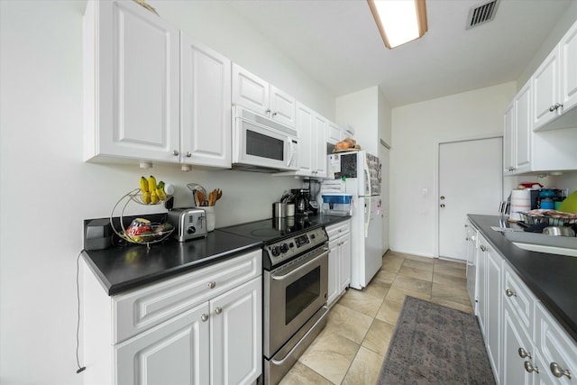 kitchen with white cabinets and white appliances