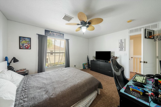 carpeted bedroom with ceiling fan and a textured ceiling