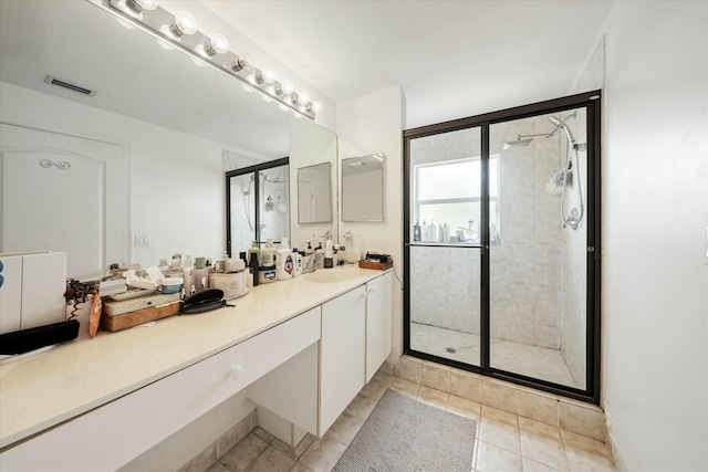 bathroom featuring tile patterned floors, vanity, and an enclosed shower