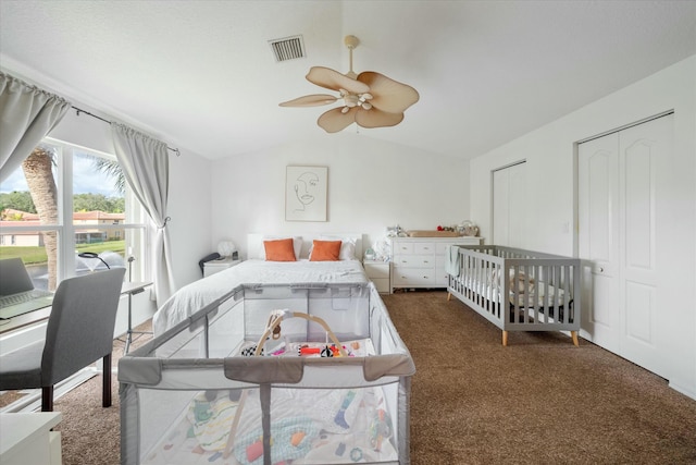 carpeted bedroom with ceiling fan and vaulted ceiling