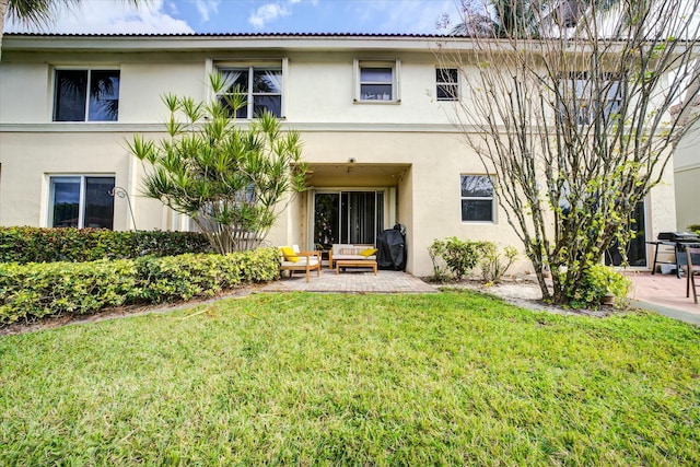 view of front of home with a patio and a front yard