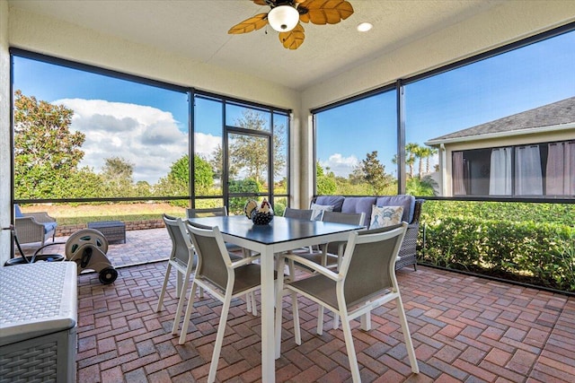 sunroom / solarium featuring ceiling fan