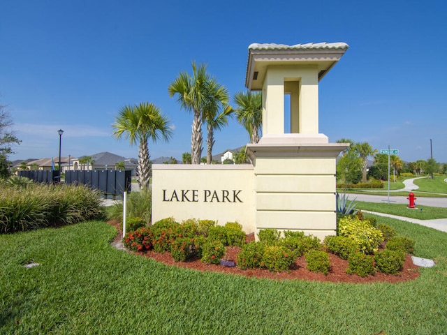 community / neighborhood sign with a lawn