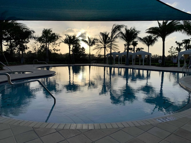 pool at dusk with a patio