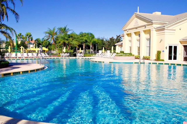 view of pool with french doors and a patio