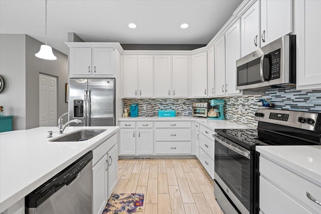 kitchen featuring sink, white cabinetry, and stainless steel appliances