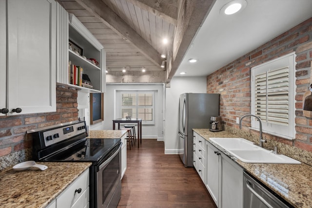 kitchen with dark wood-type flooring, sink, beamed ceiling, white cabinetry, and stainless steel appliances