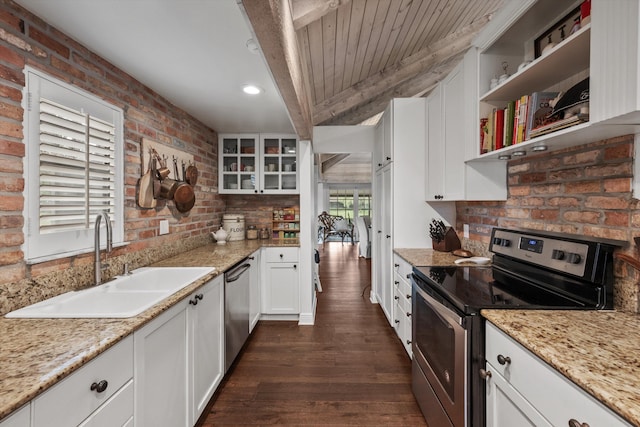 kitchen with sink, dark hardwood / wood-style floors, appliances with stainless steel finishes, beam ceiling, and white cabinetry