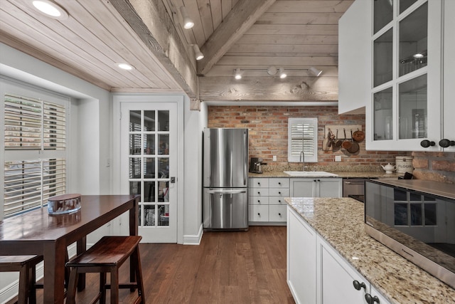 kitchen with white cabinets, dark hardwood / wood-style flooring, wood ceiling, and appliances with stainless steel finishes