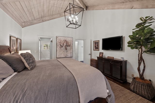 bedroom with vaulted ceiling with beams, ensuite bathroom, an inviting chandelier, and wooden ceiling