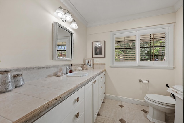 bathroom featuring tile patterned flooring, vanity, toilet, and crown molding