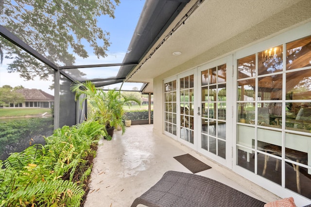 view of patio / terrace featuring french doors and glass enclosure