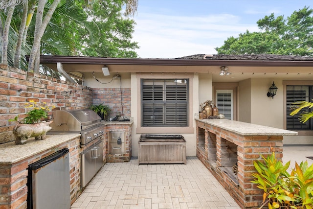 view of patio / terrace featuring a grill and exterior kitchen