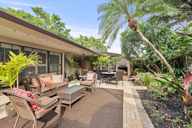 view of patio featuring an outdoor living space with a fireplace