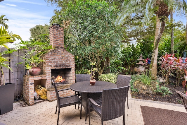 view of patio with an outdoor brick fireplace