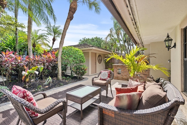 balcony featuring an outdoor living space and a patio