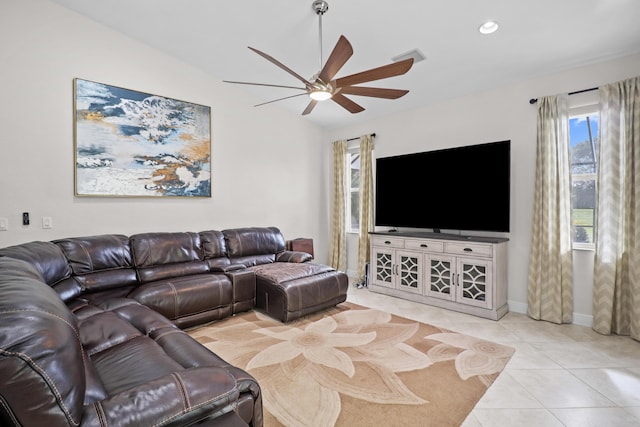 tiled living room with ceiling fan and vaulted ceiling