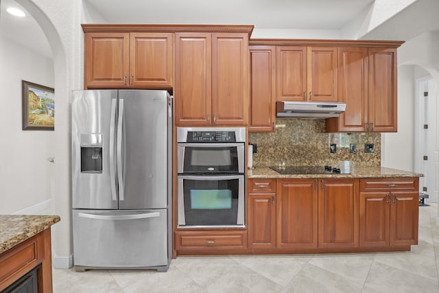 kitchen featuring decorative backsplash, light stone counters, and stainless steel appliances