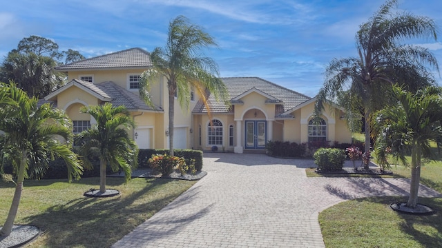 mediterranean / spanish-style home featuring a front yard