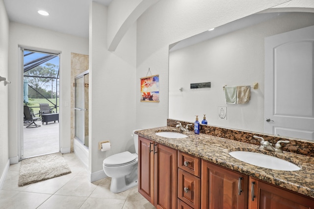 full bathroom featuring shower / bath combination with glass door, tile patterned flooring, vanity, and toilet