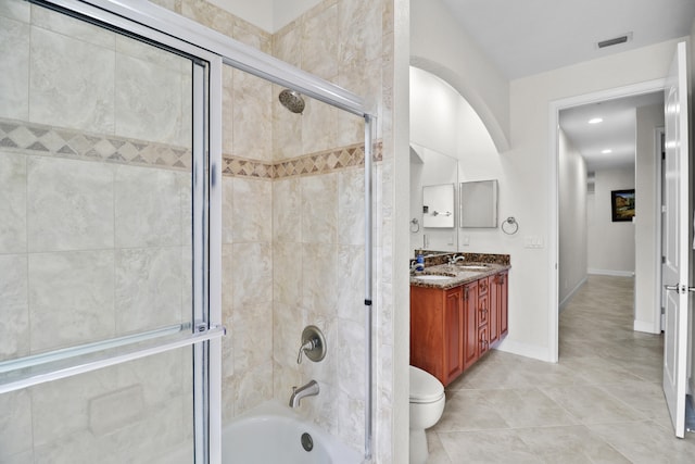 full bathroom featuring tile patterned floors, vanity, bath / shower combo with glass door, and toilet